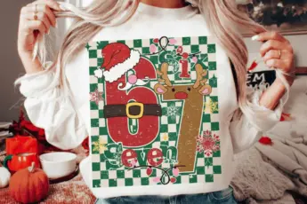 Funny Christmas meme sweatshirt featuring the “Six Seven” holiday design with Santa hat, reindeer antlers, belt graphic, snowflakes, Christmas lights, and green checkered background—perfect for festive apparel, holiday outfits, and Christmas-themed gifts.